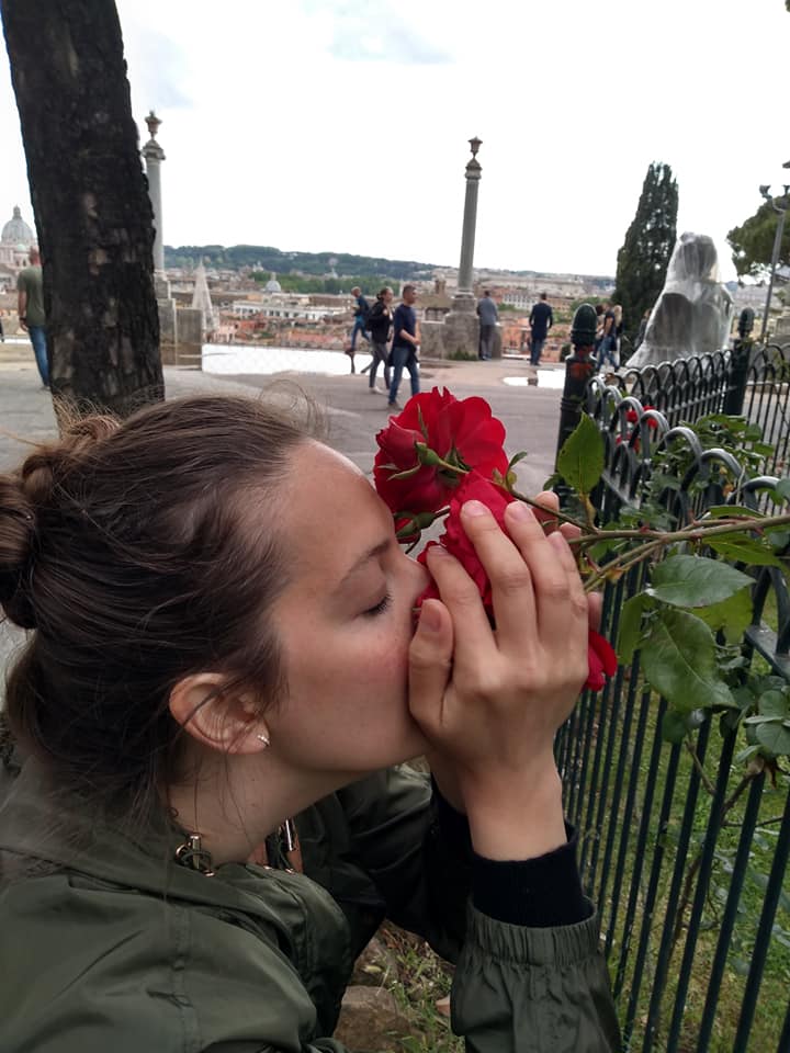 Beautiful wife stop and smell the roses in Rome Italy
